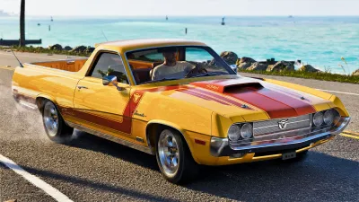 A yellow muscle car parked on the Leonida coast road in official GTA VI gameplay footage
