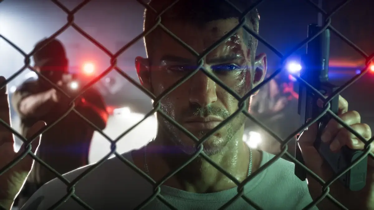 Official GTA VI art of Jason Duval behind a chain-link fence with police lights behind him
